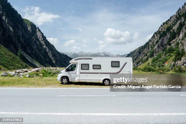camper van parked on a mountain road is enjoying the view of the valley - mountain road stock pictures, royalty-free photos & images