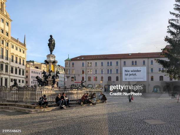Large banner on a building in Augsburg, Swabia, Bavaria, Germany, on January 24 displays the message 'Nie wieder ist jetzt' from the city...