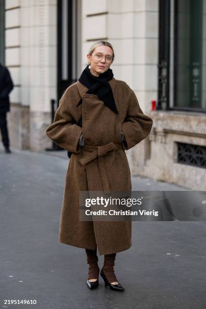Melissa Jane Tarling wears brown coat, pants outside Auralee during the Menswear Fall Winter 2025/2026 as part of Paris Fashion Week on January 21,...
