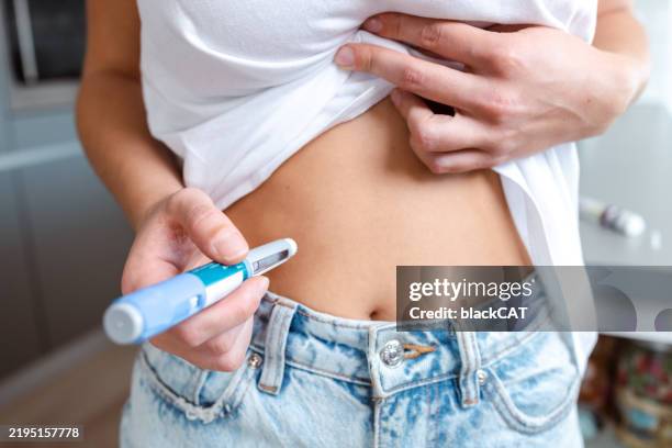person administering insulin injection using a pen - hyperglycemia stock pictures, royalty-free photos & images