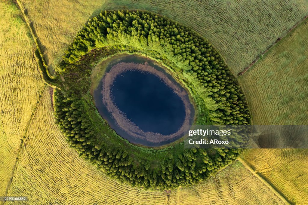 Aerial view of beautiful lagoon in Azores islands. Drone landscape with lines and textures in the background. Top view of volcanic crater, tourist attraction of Portugal.