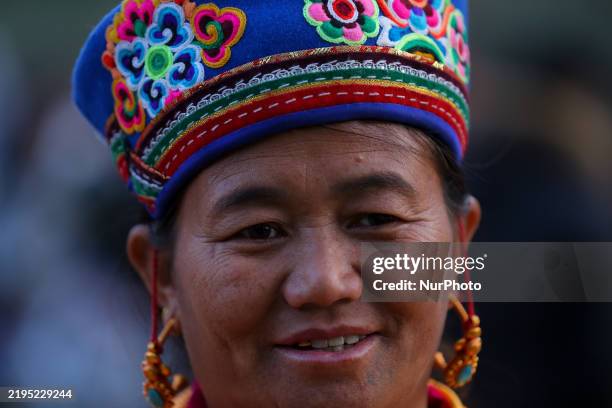 Member of Nepal's indigenous Tamang community poses for a photo as they gather to mark the pre-celebration of Sonam Lhosar on the outskirts of...