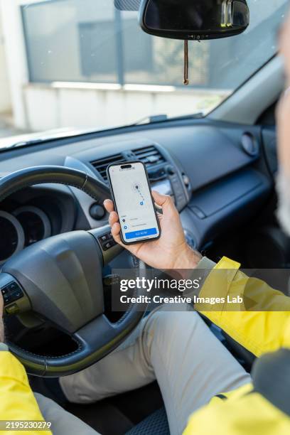driver using gps navigation on smartphone while driving car - verkehrsberuf stock-fotos und bilder