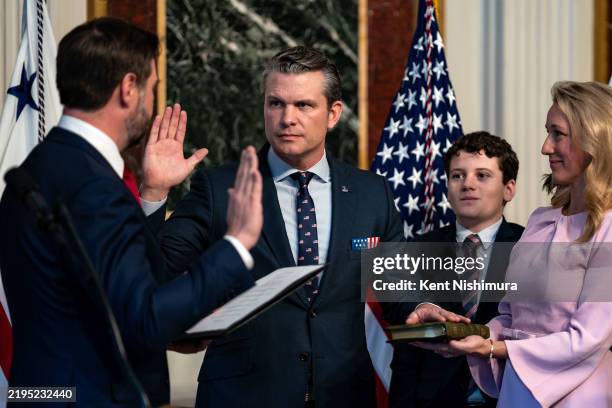 Vice President J.D. Vance swears in Secretary of Defense Pete Hegseth alongside his wife Jennifer Rauchet in the Indian Treaty Room in the Eisenhower...