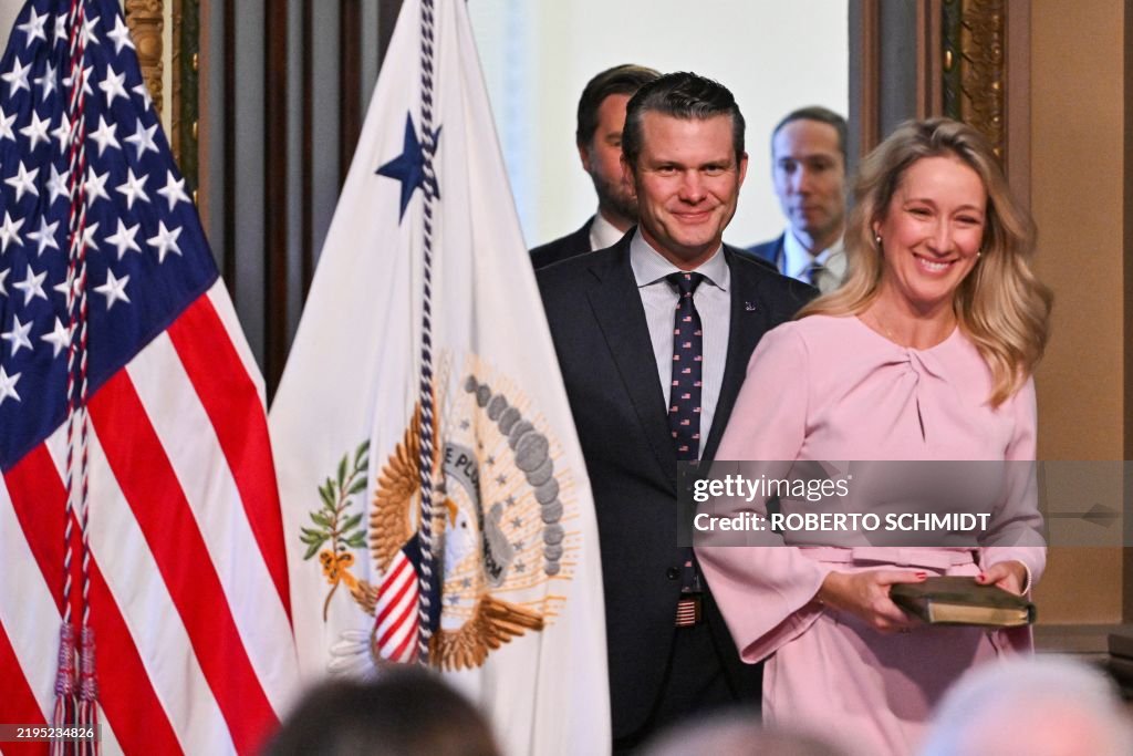 Pete Hegseth and his wife Jennifer Rauchet walk in for his swearing