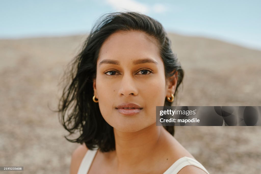 Portrait of Young Woman Outdoors with Natural Soft Lighting and Neutral Background