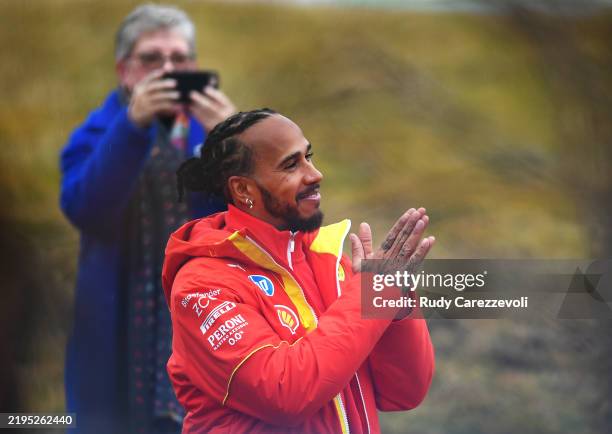 Lewis Hamilton of Great Britain and Ferrari greets the crowd during his first official days as a Scuderia Ferrari F1 driver at Fiorano Circuit on...