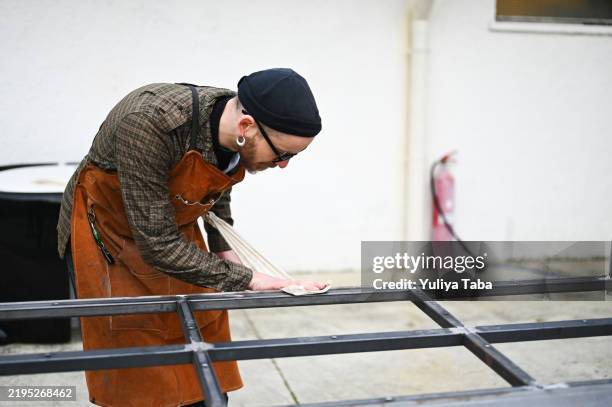 carpenter in apron working portrait. - blacksmith forge stock pictures, royalty-free photos & images