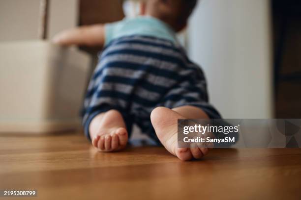 unrecognizable baby boy crawling - krabbeln stock-fotos und bilder
