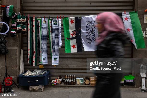 New Syrian flags are sold on a street in the city of Homs on January 22, 2025 in Homs, Syria. Homs, the country’s third-largest city, has a mixed...