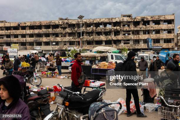 People visit a market in the city of Homs on January 22, 2025 in Homs, Syria. Homs, the country’s third-largest city, has a mixed population of Sunni...