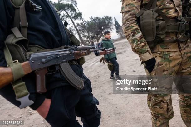 Fighters with the insurgent group Hayat Tahrir al-Sham, or HTS, patrol in the city of Homs on January 22, 2025 in Homs, Syria. Homs, the country’s...