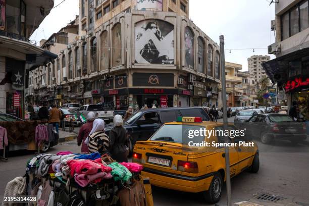 People walk through a shopping district in the city of Homs on January 22, 2025 in Homs, Syria. Homs, the country’s third-largest city, has a mixed...