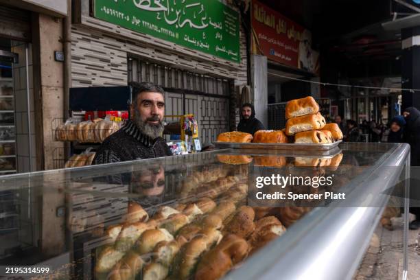 Man sells pastries on a street in the city of Homs on January 22, 2025 in Homs, Syria. Homs, the country’s third-largest city, has a mixed population...