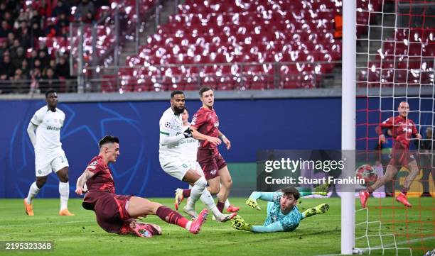 Benjamin Sesko of RB Leipzig scores his team's first goal as Franco Israel of Sporting CP fails to make a save during the UEFA Champions League...