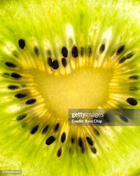 kiwi fruit cross-section in extreme close up - kiwi juice stock pictures, royalty-free photos & images