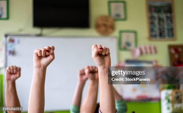 hands raised in the air - school strike stock pictures, royalty-free photos & images