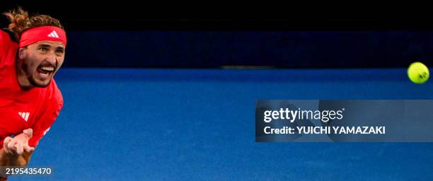 Germany's Alexander Zverev serves against Italy's Jannik Sinner during their men's singles final match on day fifteen of the Australian Open tennis...