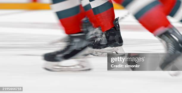 fast-paced ice hockey action with speedy skates - ice skater stock pictures, royalty-free photos & images