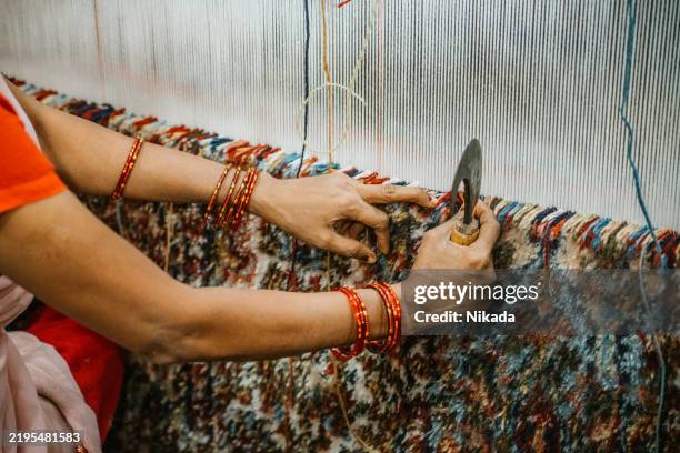 artisan handweaving a colorful carpet using traditional methods in india - craft product stock pictures, royalty-free photos & images