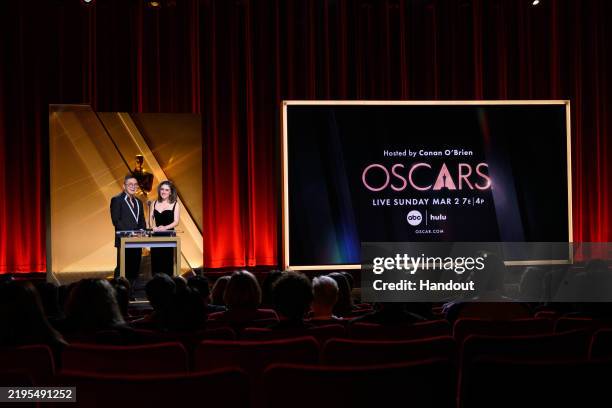 In this handout photo provided by The Academy, Bowen Yang and Rachel Sennott speak onstage during the 97th Oscars Nominations Announcement at Samuel...