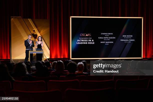 In this handout photo provided by The Academy, Bowen Yang and Rachel Sennott present the nominees for Actress in a Leading Role onstage during the...