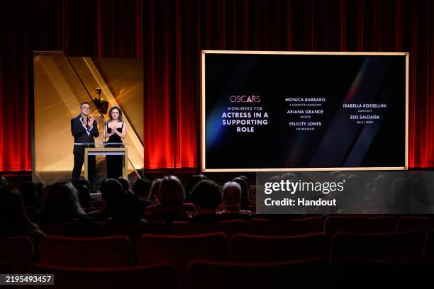 In this handout photo provided by The Academy, Bowen Yang and Rachel Sennott present the nominees for Actress in a Supporting Role onstage during the...