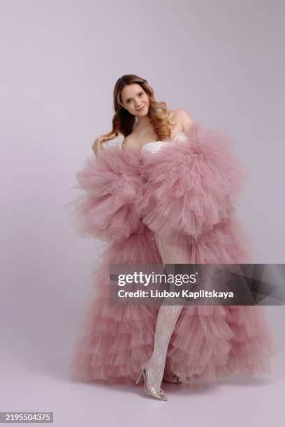 a female model poses in a pale pink, fluffy tulle dress. - the russian brides attire stock pictures, royalty-free photos & images