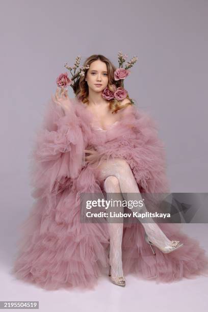 a female model poses in a pale pink, fluffy tulle dress. - high fashion stock pictures, royalty-free photos & images