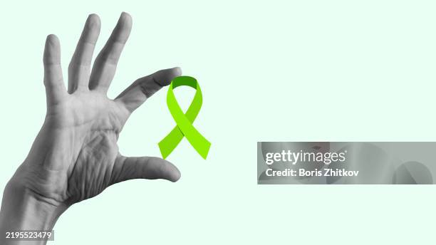 green awareness ribbon - mental health awareness ribbon stock pictures, royalty-free photos & images