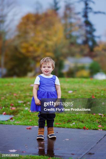 cute little boy wearing his big sister's dress over his outfit - only boys stock pictures, royalty-free photos & images