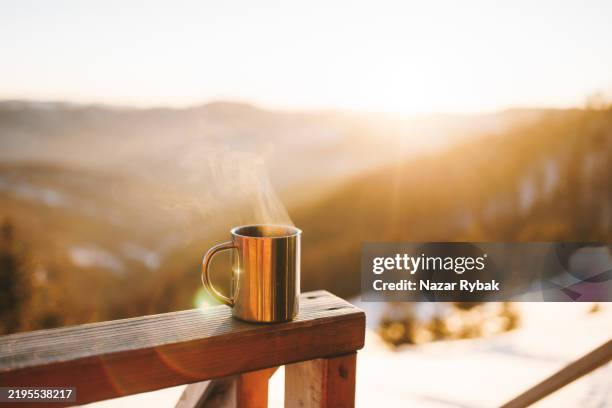 the mug of hot coffee in the winter mountains at sunrise - morning stock pictures, royalty-free photos & images