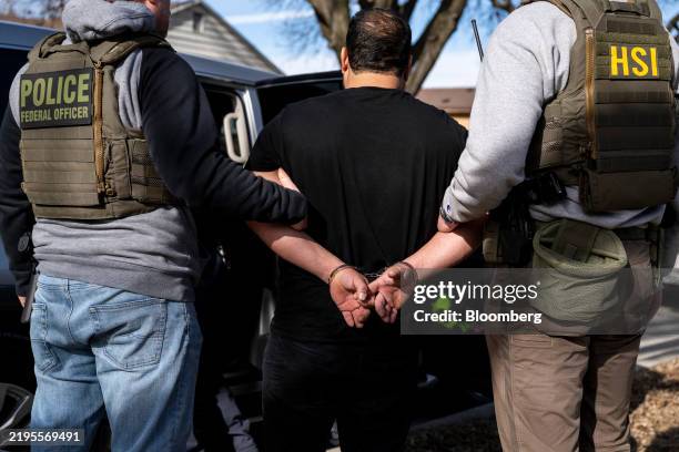 Immigration and Customs Enforcement agents detain a suspect during a multi-agency targeted enforcement operation in Lyons, Illinois, US, on Sunday,...