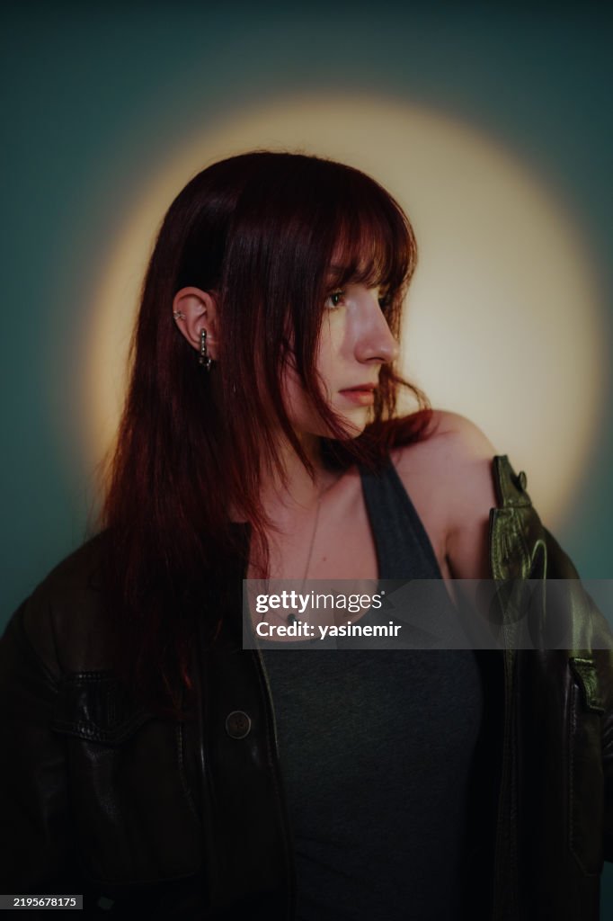 Young woman silhouette looking right on orange and purple background