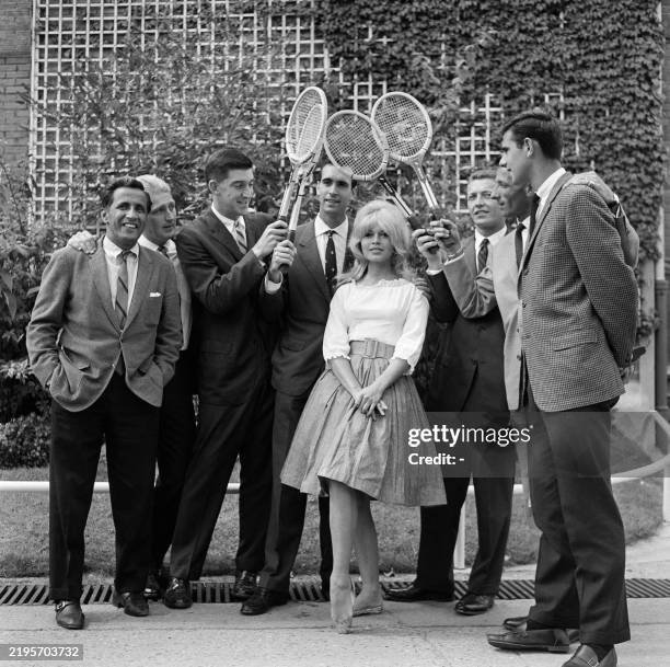 French actress Brigitte Bardot poses with the world's greatest tennis players Australian Lew Hoad, Ecuadorian-American Pancho Segura, US Barry...