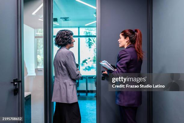 coworkers talking and entering on room at office - entering stock pictures, royalty-free photos & images
