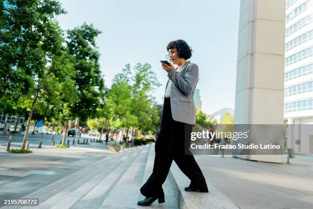 businesswoman sending a voicemail in the city - conference phone stock pictures, royalty-free photos & images