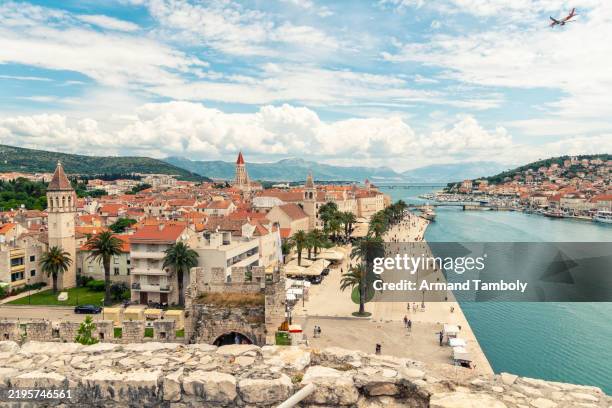 aerial view of cityscape of the coastal town of trogir with historic architecture along the adriatic sea with a clear blue sky and a drone flying overhead, trogir, croatia - trogir stock pictures, royalty-free photos & images