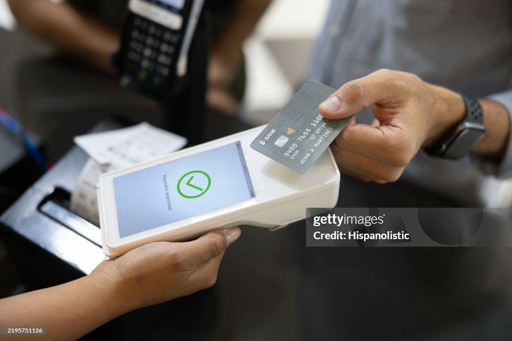Customer making a contactless payment while buying tickets at the cinema