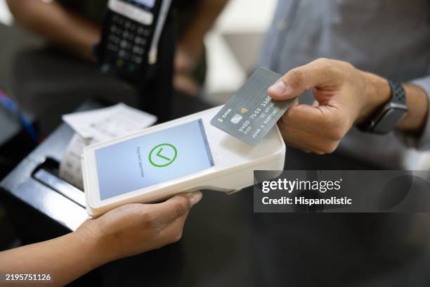 customer making a contactless payment while buying tickets at the cinema - kortläsare bildbanksfoton och bilder