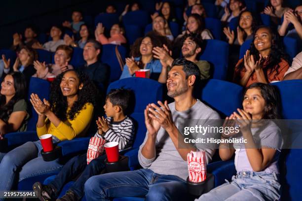 happy family applauding in the cinema after watching a movie - audience stock pictures, royalty-free photos & images