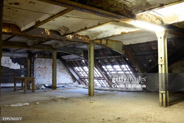 abandoned industrial building interior with sunlight streaming through broken windows onto dilapidated walls and a concrete floor, berlin, germany - urban exploration stock pictures, royalty-free photos & images