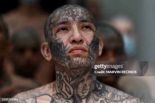 An inmate looks on as he remains in a cell at the Counter-Terrorism Confinement Centre mega-prison, where hundreds of members of the MS-13 and 18...
