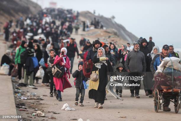 Displaced Palestinians making their way back on foot from the southern regions to their homes in the north via Al Rashid Road after the ceasefire...