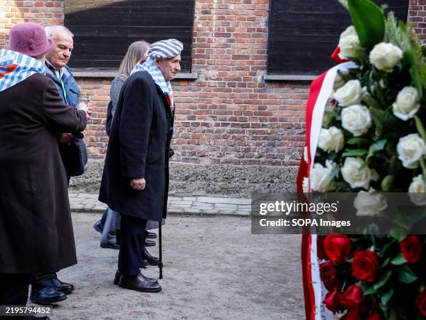 Camp survivors and their loved ones arrive to put flowers and candles by the Wall of Death in Auschwitz - Birkenau Museum during the 80th anniversary...