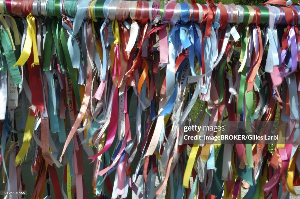 Aveiro, A vibrant array of colorful ribbons hanging from a bar, creating a festive atmosphere