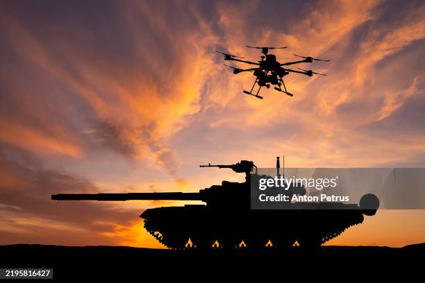 military drone with a bombs over the armored tank - exercício militar imagens e fotografias de stock