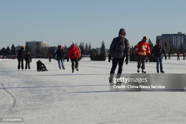 Ice skaters glide along the Rideau Canal Skateway, the world's largest natural ice skating rink, on January 24, 2025 in Ottawa, Ontario of Canada....