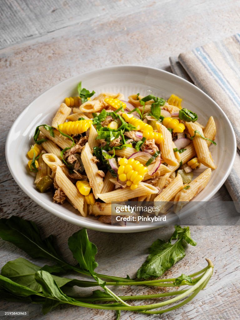 Penne pasta with tuna, corn and vegetable. Pasta salad with vegetables. Pasta salad with vegetables and tuna.