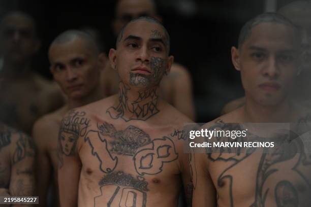 Inmates look on as they remain in a cell at the Counter-Terrorism Confinement Centre mega-prison, where hundreds of members of the MS-13 and 18...
